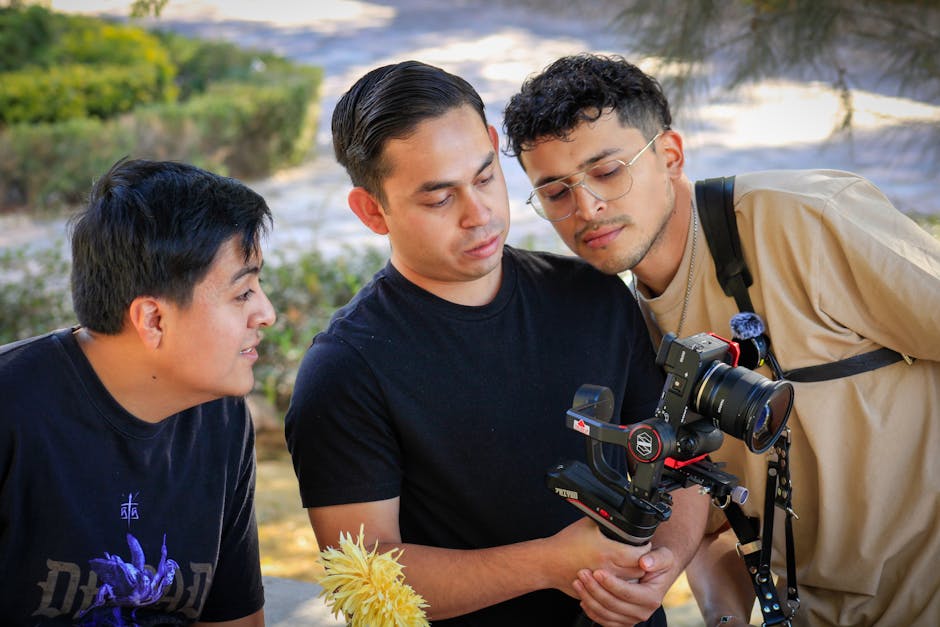 Three men reviewing camera footage on a gimbal outdoors in Ibarrilla, Guanajuato, México.